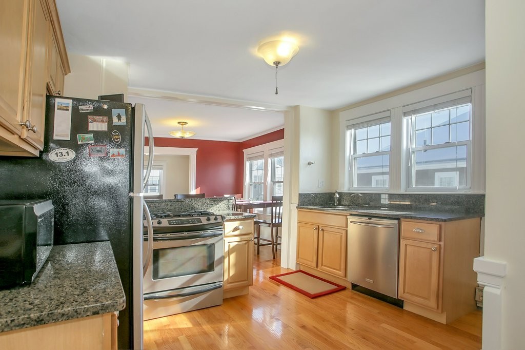 14 Russell Road, Unit 14 Winchester, MA 01890 - Photo 9 of 18 a kitchen with granite countertop a stove oven and sink