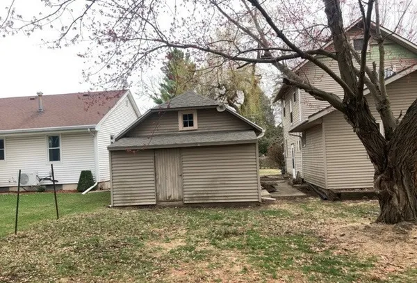 a view of a house with a yard and garage