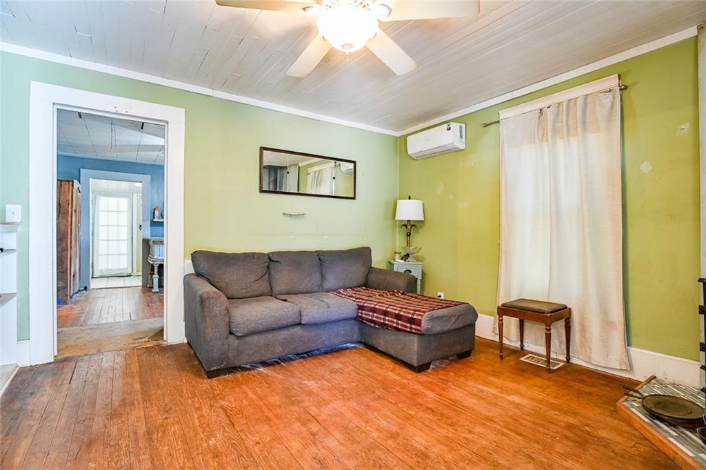 12462 Brown Bridge Road Covington, GA 30016 - Photo 5 of 31 a living room with furniture a large window and a flat screen tv