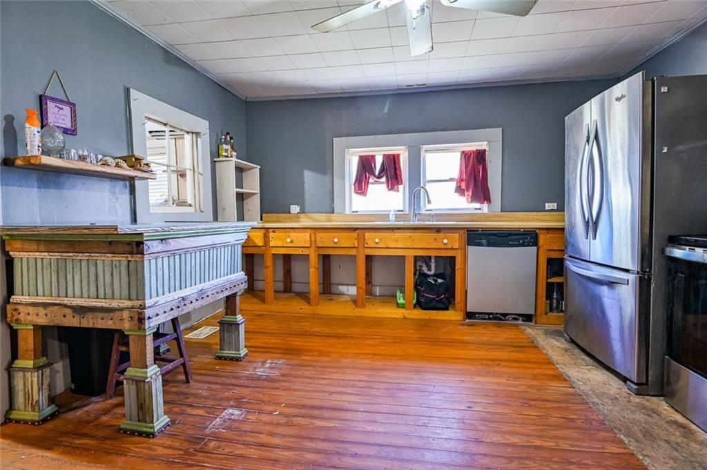 12462 Brown Bridge Road Covington, GA 30016 - Photo 10 of 31 a living room with stainless steel appliances kitchen island granite countertop furniture and a fireplace