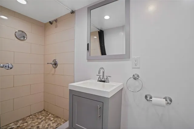 a bathroom with a sink toilet and shower