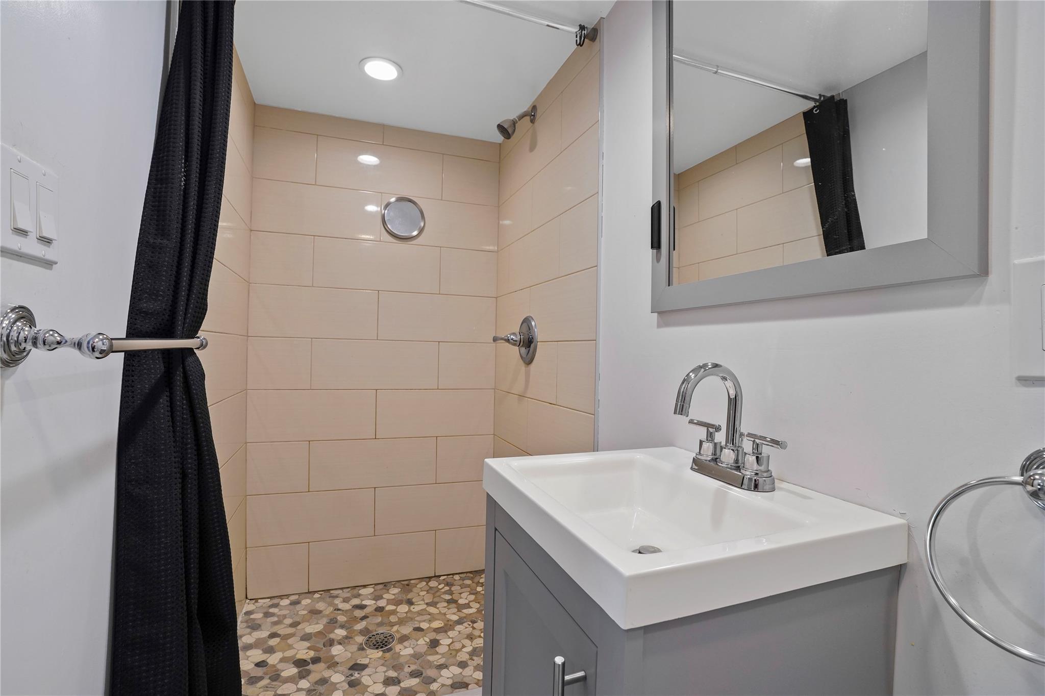 64-18 84th Place Queens, NY 11379 - Photo 18 of 35 a bathroom with a sink a toilet a mirror and shower