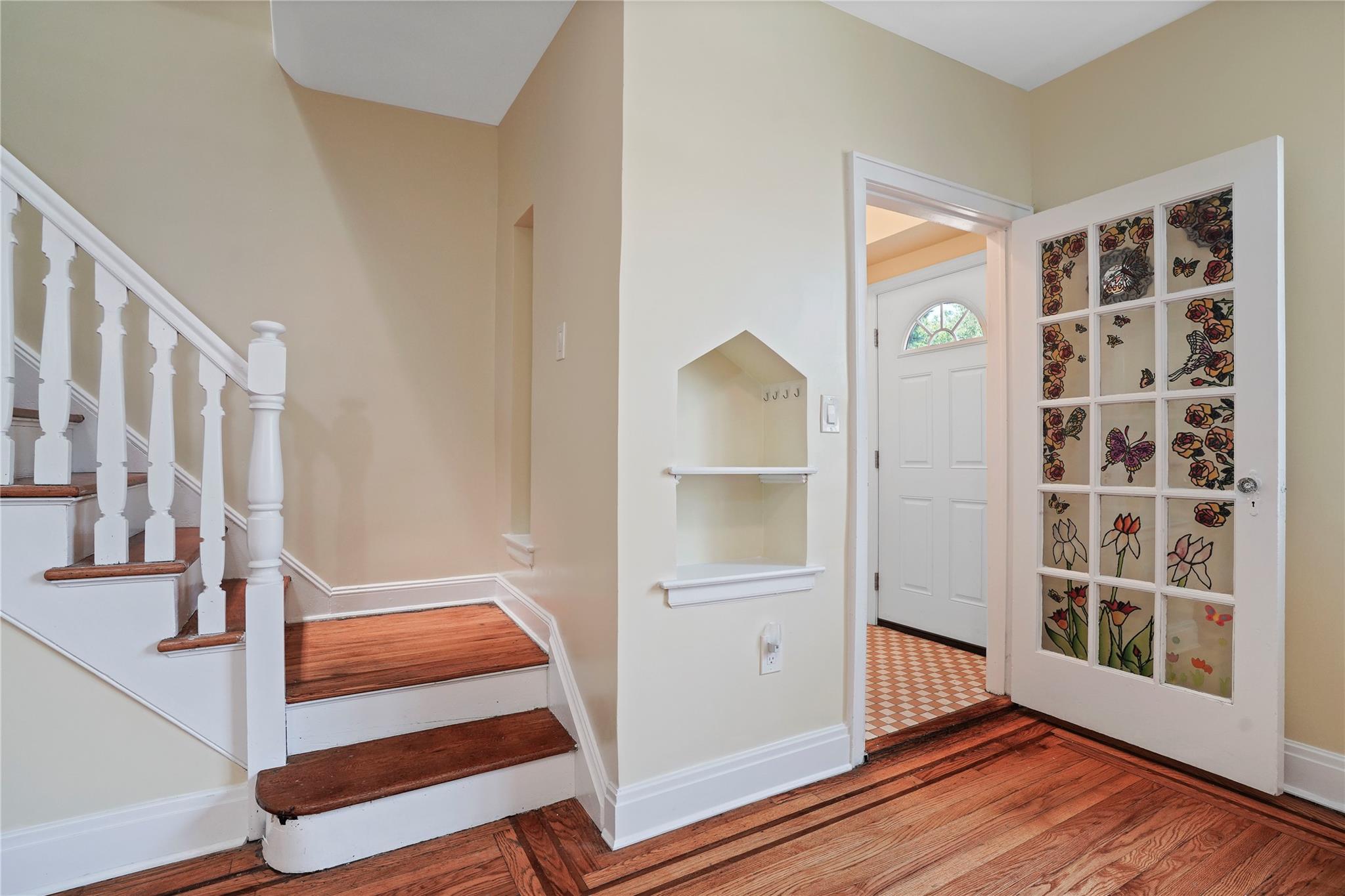 64-18 84th Place Queens, NY 11379 - Photo 2 of 35 a view of front door with wooden floor and windows