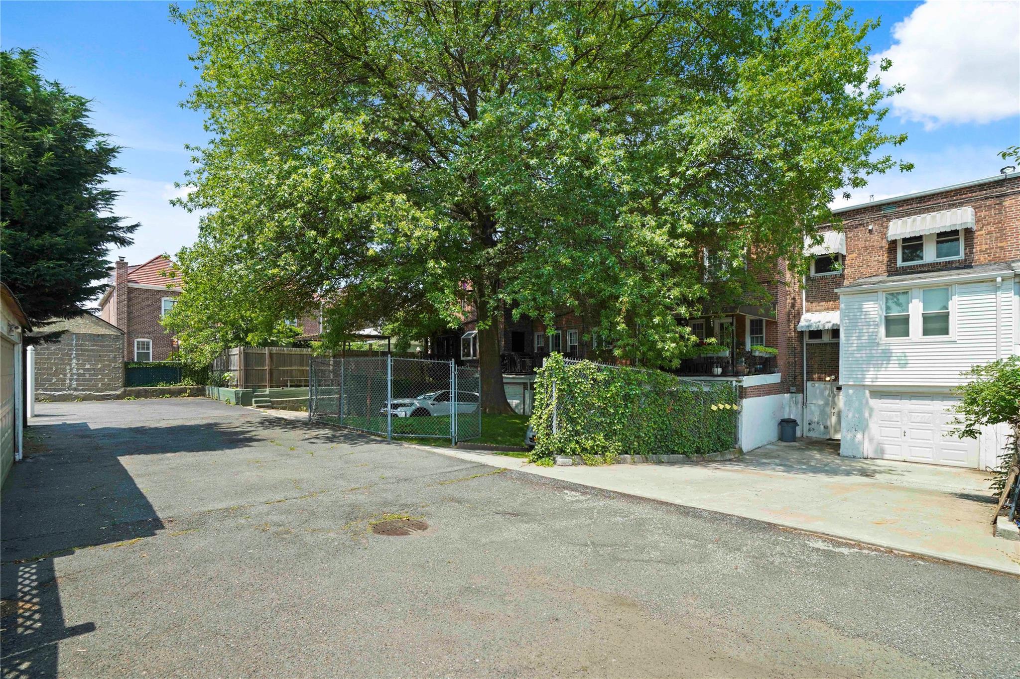 64-18 84th Place Queens, NY 11379 - Photo 24 of 35 a house with trees in front of it
