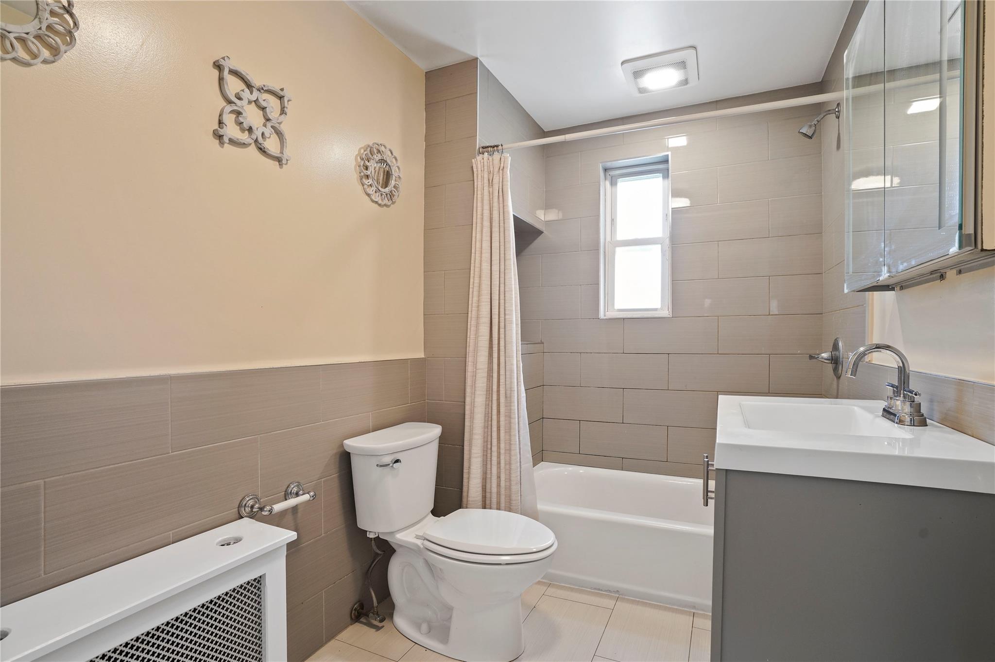 64-18 84th Place Queens, NY 11379 - Photo 25 of 35 a bathroom with a sink a toilet and shower