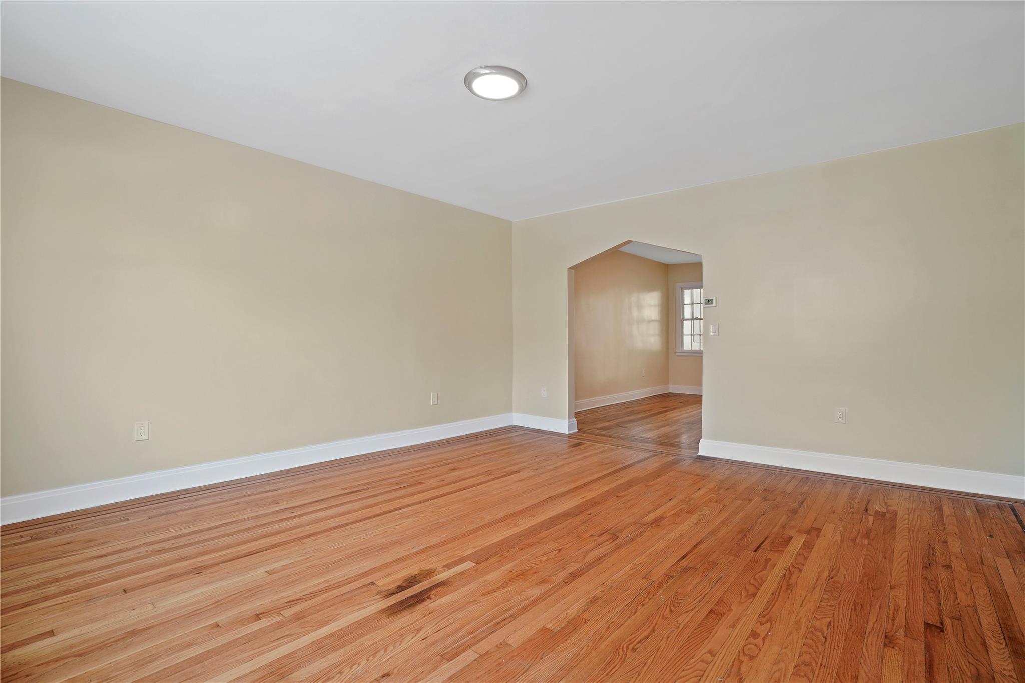 64-18 84th Place Queens, NY 11379 - Photo 3 of 35 wooden floor in an empty room with wooden floor