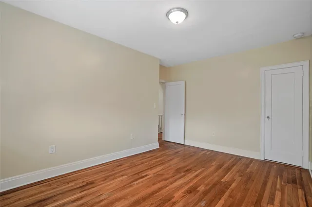 a view of a room with wooden floor and window