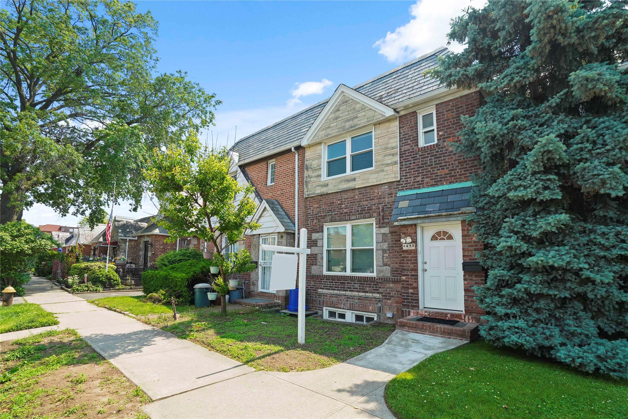 64-18 84th Place Queens, NY 11379 - Photo 34 of 35 a front view of a house with a garden