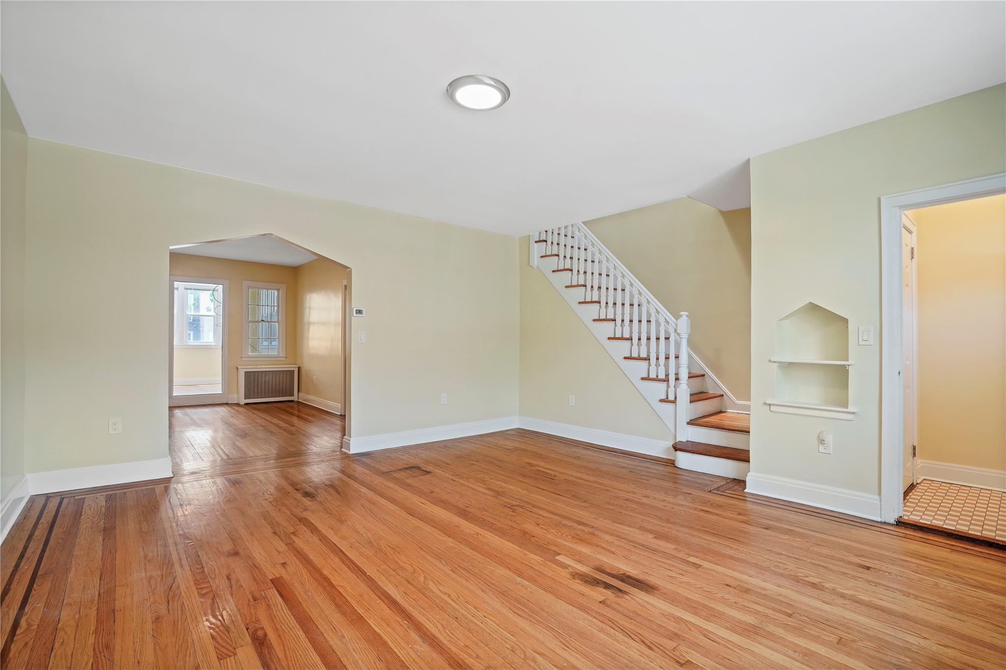 64-18 84th Place Queens, NY 11379 - Photo 4 of 35 wooden floor in an empty room with a window