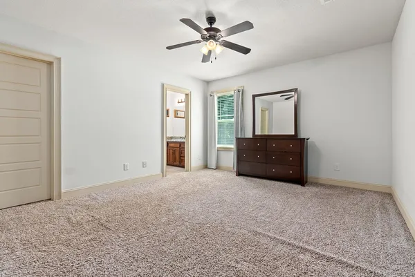 a big room with closet and a chandelier fan