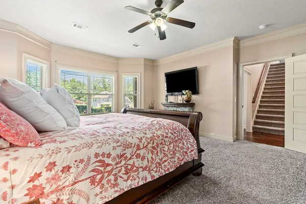a bedroom with a large bed and a flat screen tv