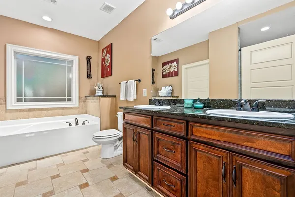 a bathroom with a sink a toilet and bathtub