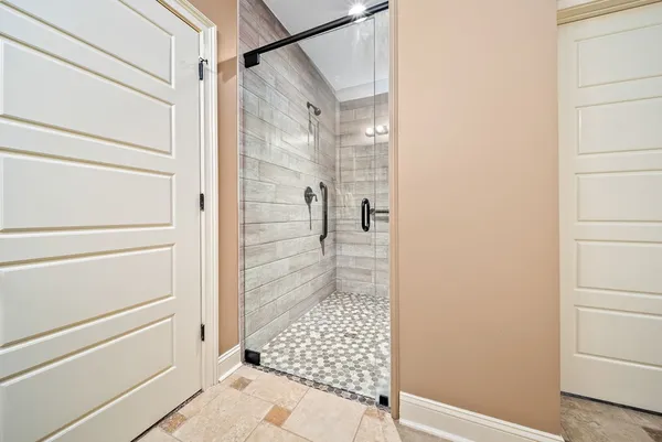 a bathroom with a shower and a sink