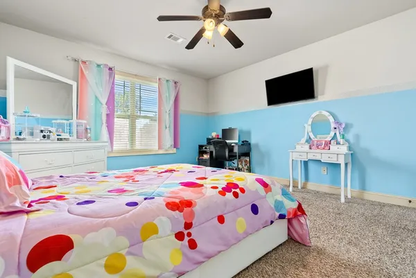 a bedroom that has a bed and a table in it