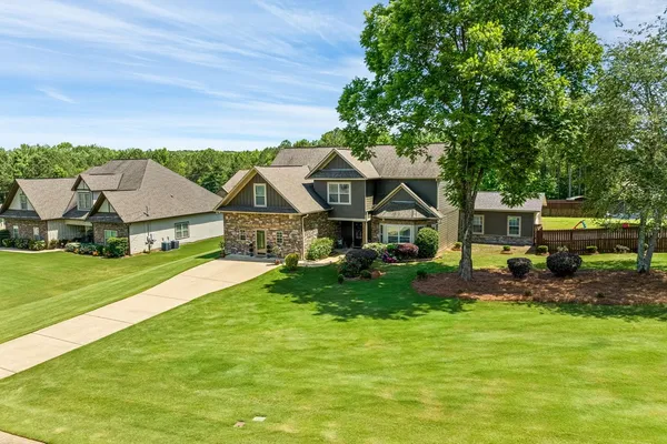 a front view of house with yard and green space