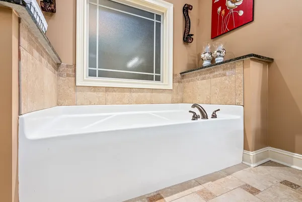 a white bath tub sitting next to a window
