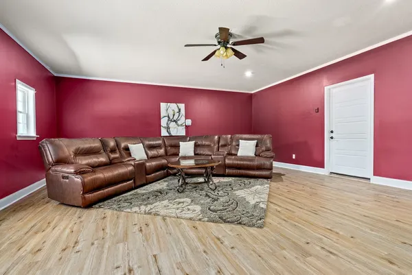 a living room with furniture and a wooden floor
