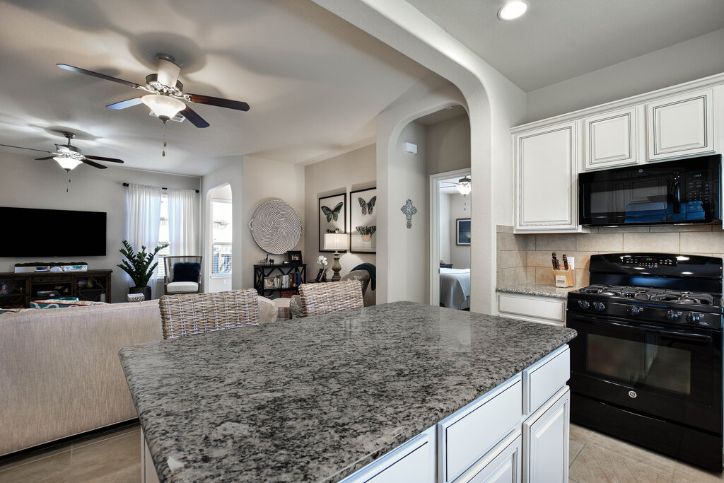 3451 Mayfield Ranch Boulevard, Unit 216 Round Rock, TX 78681 - Photo 33 of 33 a kitchen with stainless steel appliances granite countertop a sink a stove top oven a counter space and cabinets