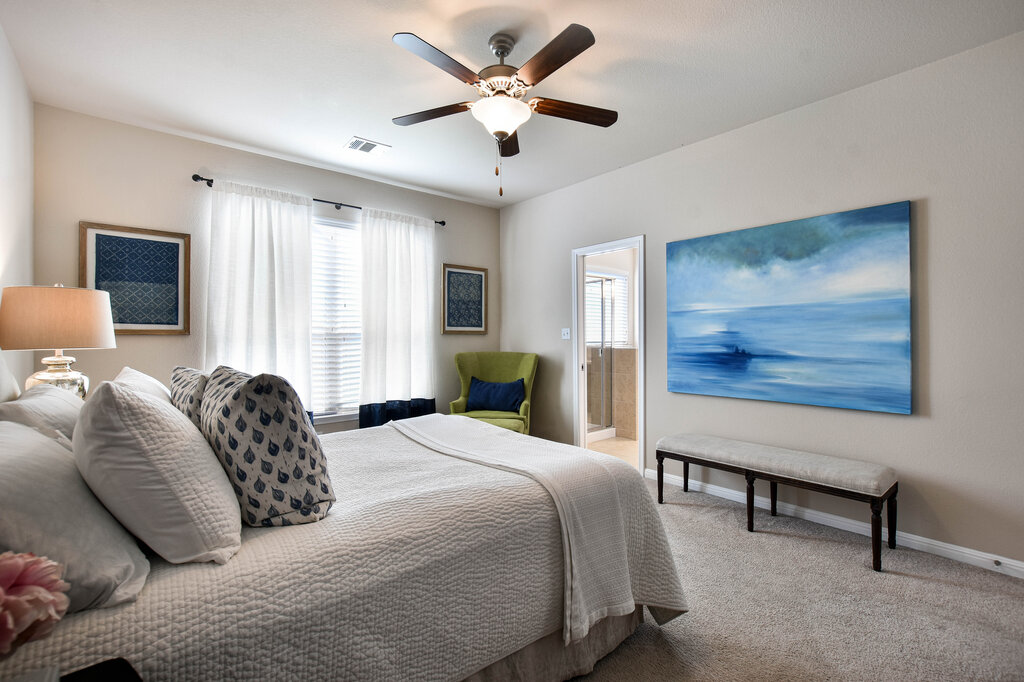 3451 Mayfield Ranch Boulevard, Unit 216 Round Rock, TX 78681 - Photo 17 of 33 a bedroom with a bed and a chandelier