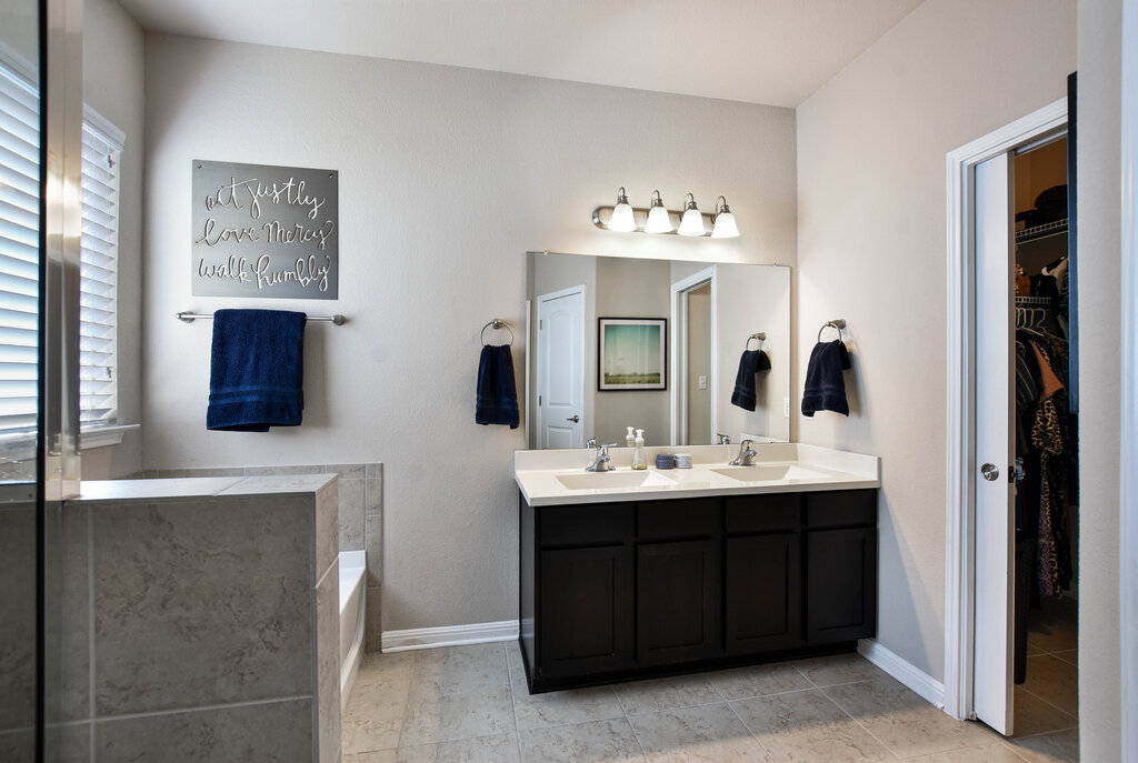 3451 Mayfield Ranch Boulevard, Unit 216 Round Rock, TX 78681 - Photo 18 of 33 a bathroom with a double vanity sink and a mirror