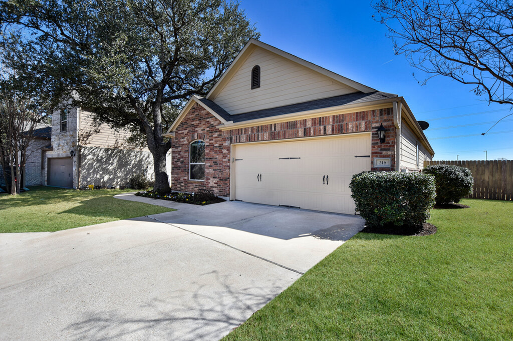 3451 Mayfield Ranch Boulevard, Unit 216 Round Rock, TX 78681 - Photo 2 of 33 a front view of a house with a yard