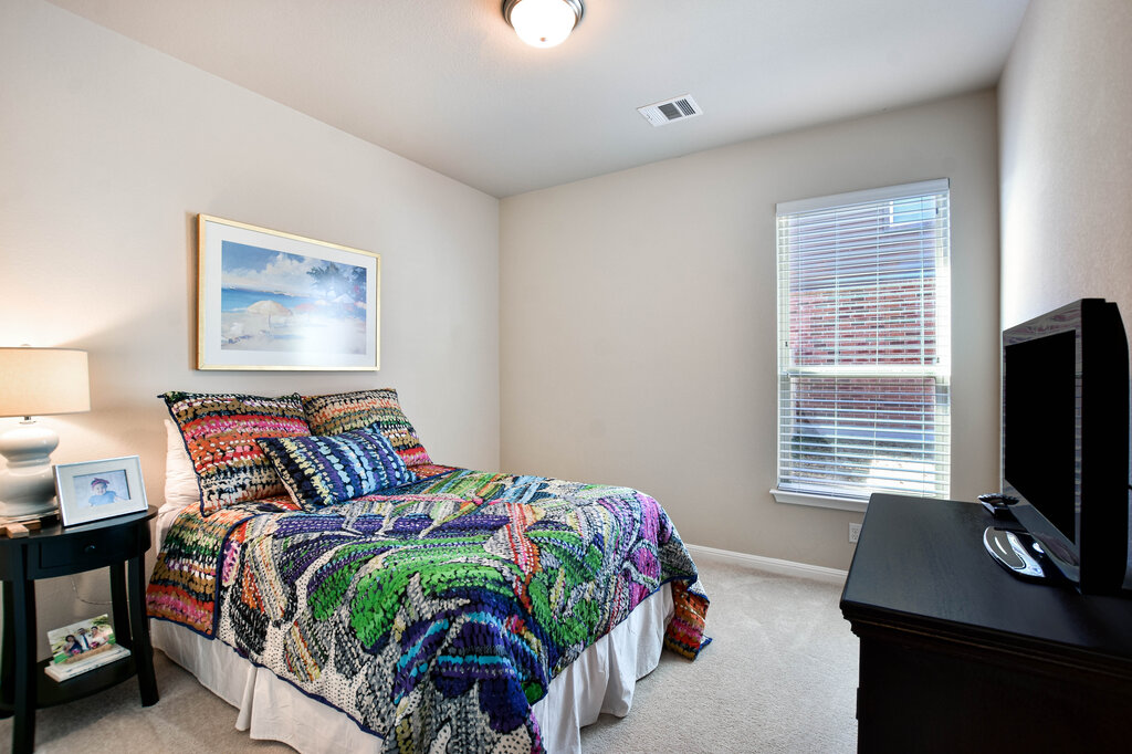 3451 Mayfield Ranch Boulevard, Unit 216 Round Rock, TX 78681 - Photo 22 of 33 a bedroom with a bed and a flat screen tv