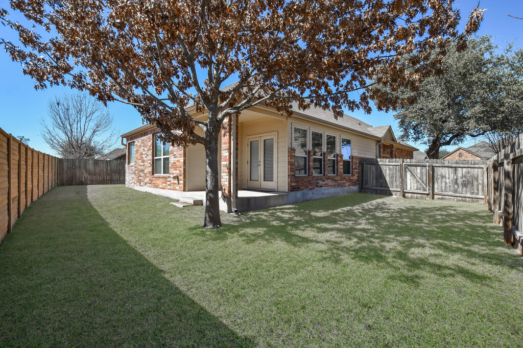 3451 Mayfield Ranch Boulevard, Unit 216 Round Rock, TX 78681 - Photo 27 of 33 a front view of a house with a yard and garage