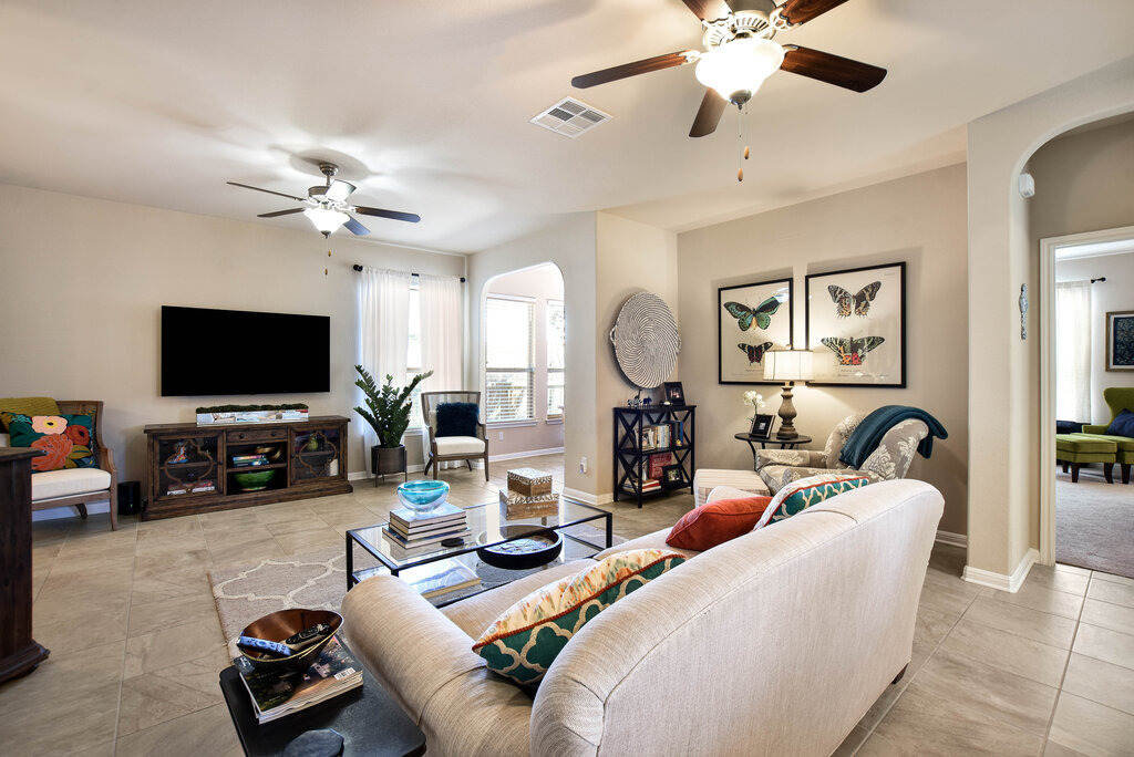 3451 Mayfield Ranch Boulevard, Unit 216 Round Rock, TX 78681 - Photo 8 of 33 a living room with furniture a flat screen tv and a chandelier