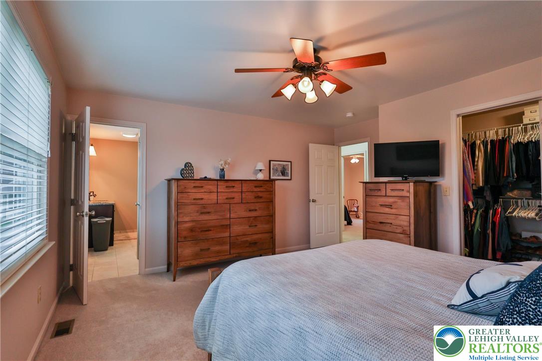2053 Alice Drive Bethlehem, PA 18015 - Photo 14 of 31 a bedroom with a bed and a flat tv screen on dresser