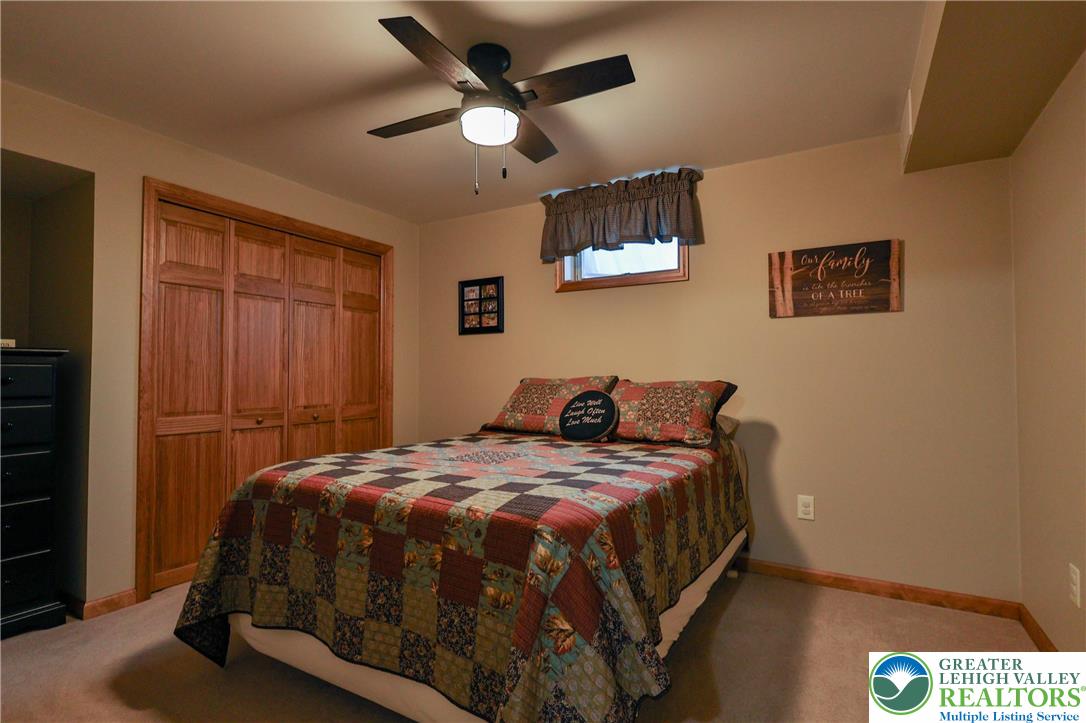 2053 Alice Drive Bethlehem, PA 18015 - Photo 25 of 31 a bedroom with a bed and a chandelier