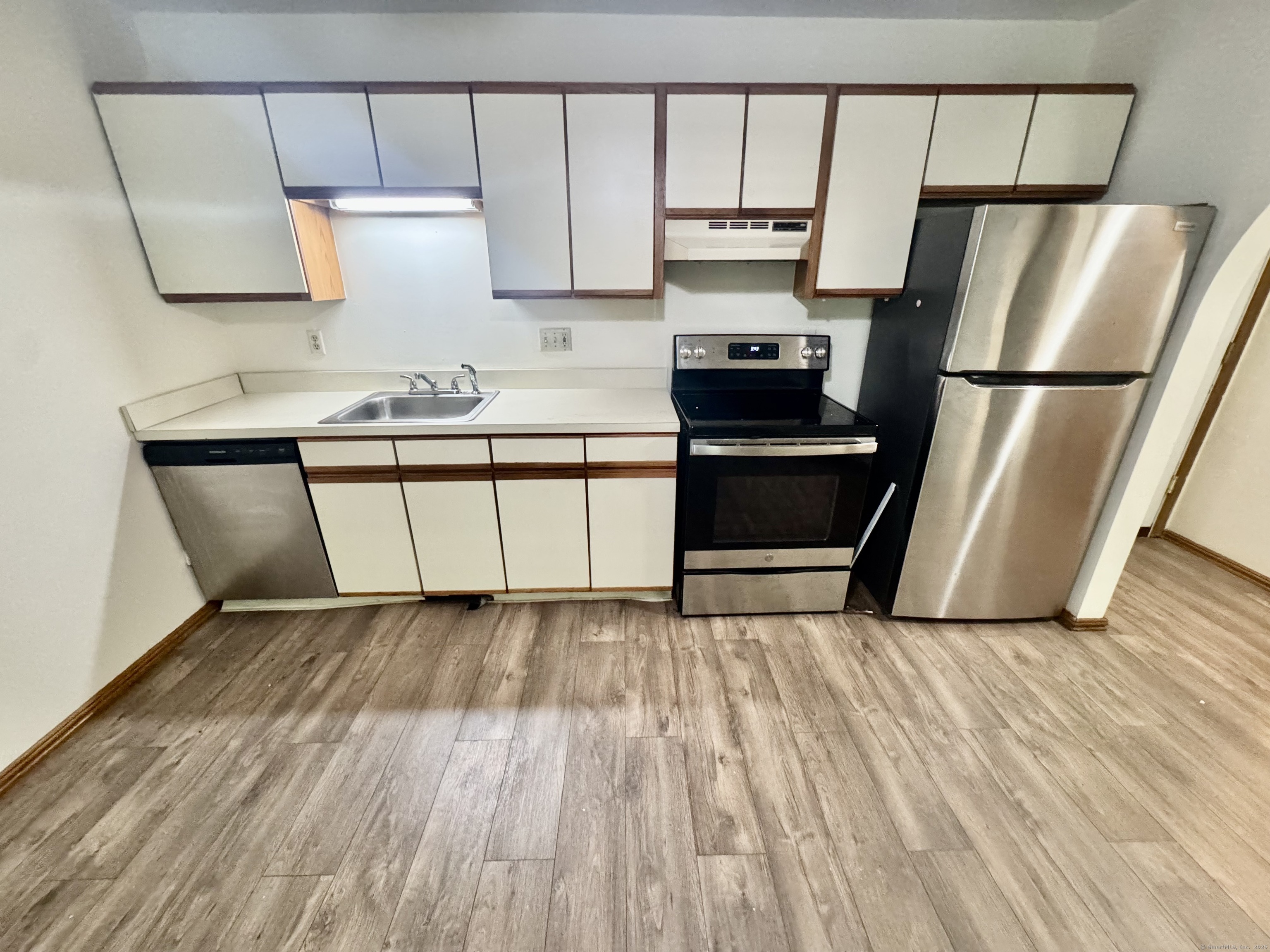 24 West Road, Unit 44 Ellington, CT 06029 - Photo 2 of 9 a kitchen with granite countertop a sink a stove and a refrigerator