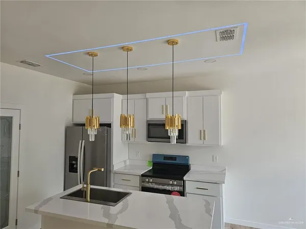 a kitchen with a refrigerator and a sink