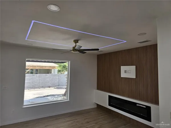 a view of room with window and a ceiling fan