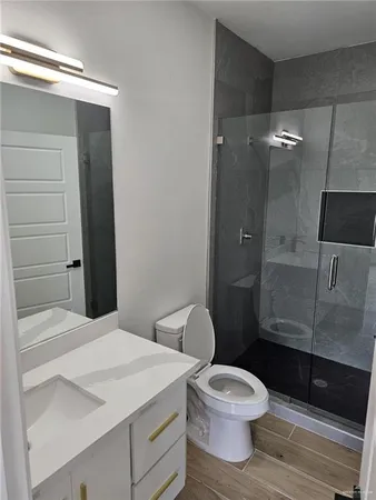 a bathroom with a toilet a sink and shower