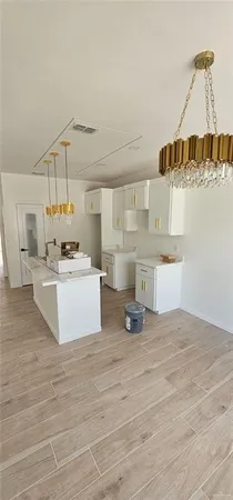 a view living room with kitchen island stainless steel appliances wooden floor and living room view