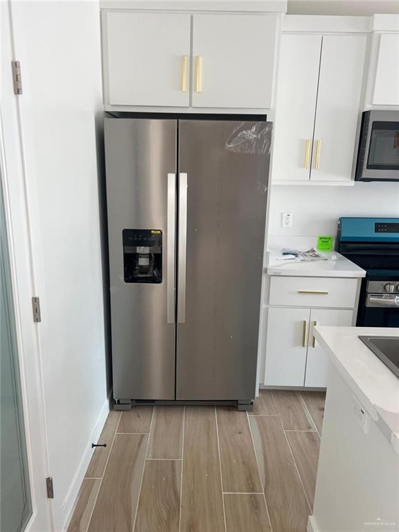 5500 North Crown Point Pharr, TX 78577 - Photo 36 of 39 a kitchen with a refrigerator and a stove top oven