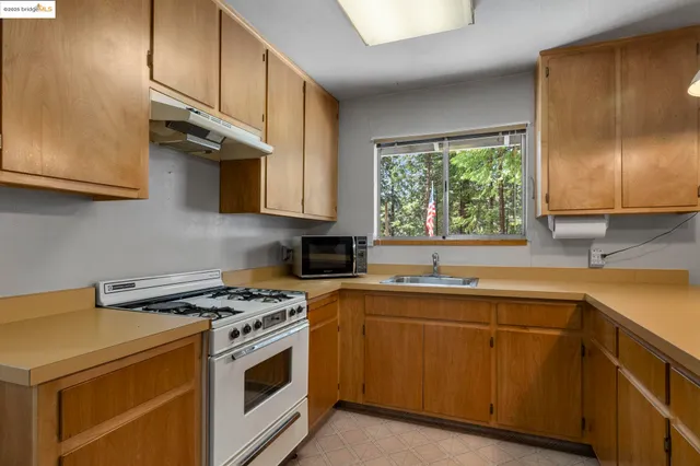 a kitchen with a sink window and cabinets
