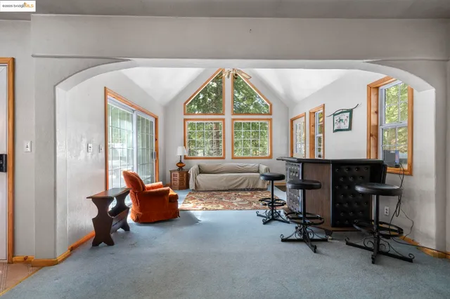 a bedroom with a bed and a couch next to a window