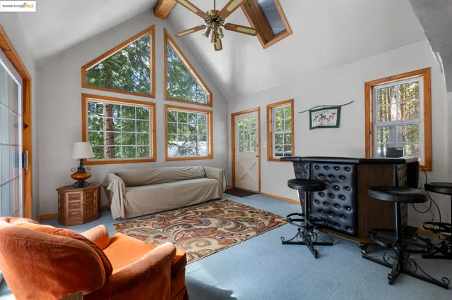 a living room with furniture and kitchen view