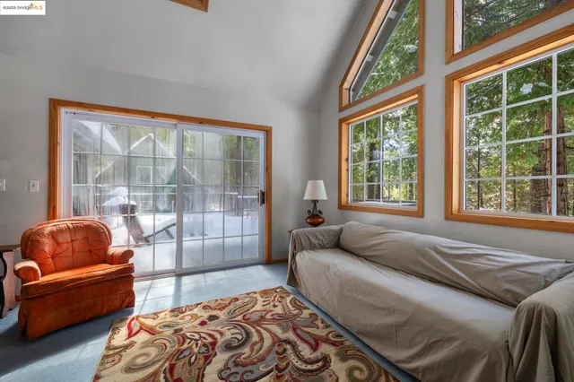 a kitchen with a dining table chairs and refrigerator