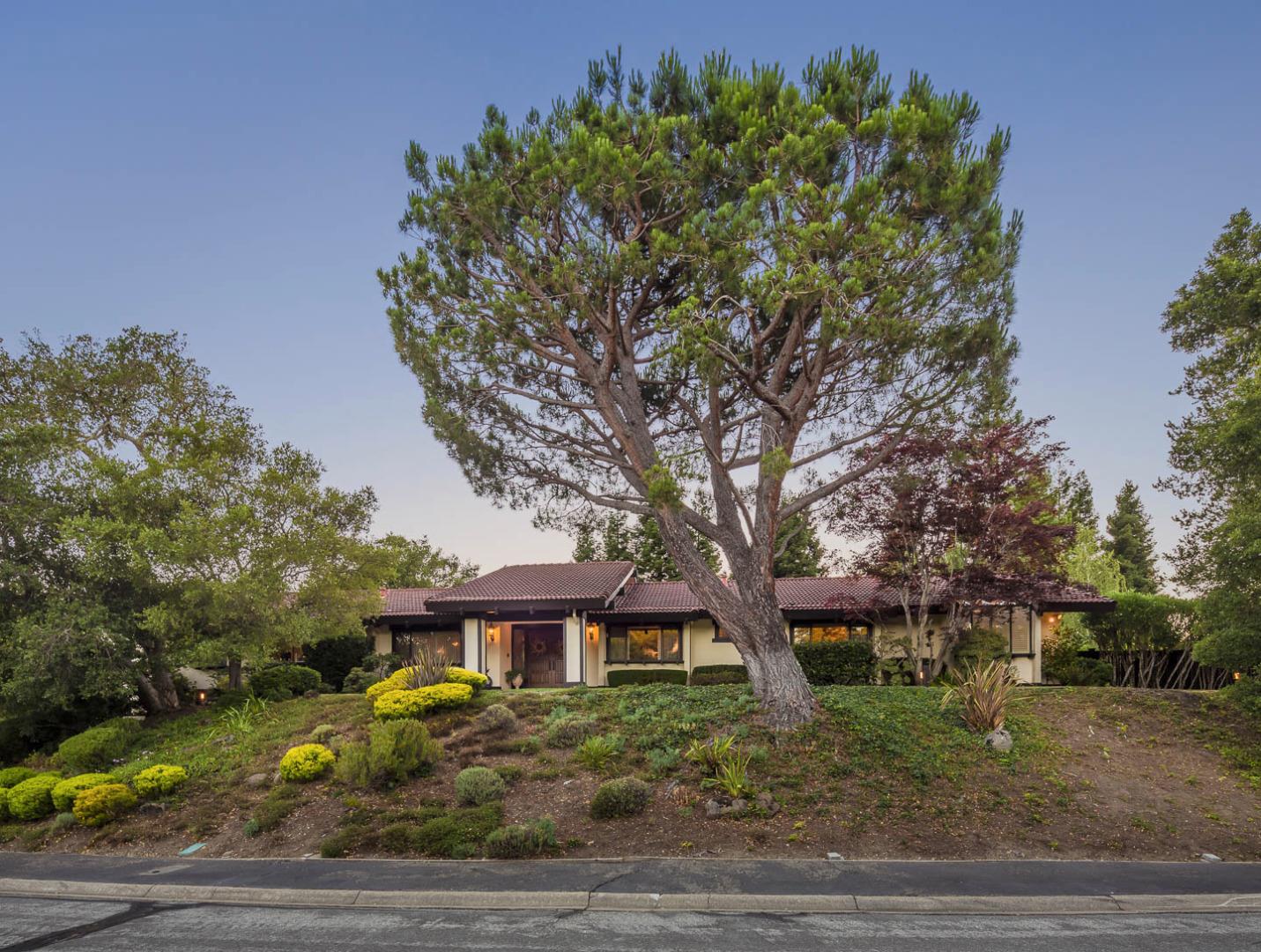 a front view of a house with a garden