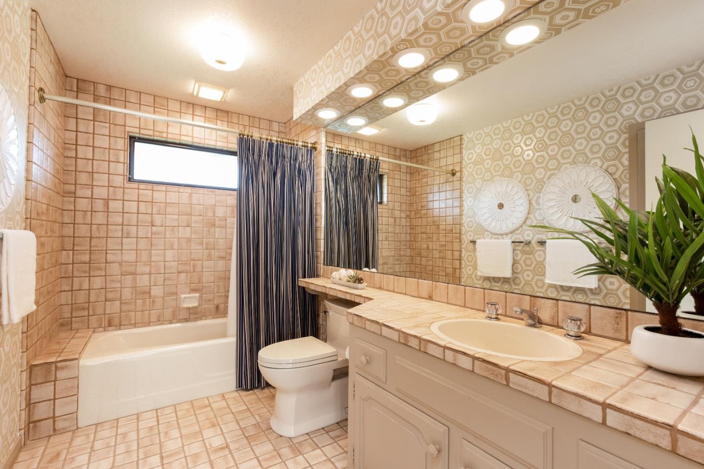 110 Stonepine Road Hillsborough, CA 94010 - Photo 19 of 28 a bathroom with a granite countertop sink a toilet a mirror and bathtub
