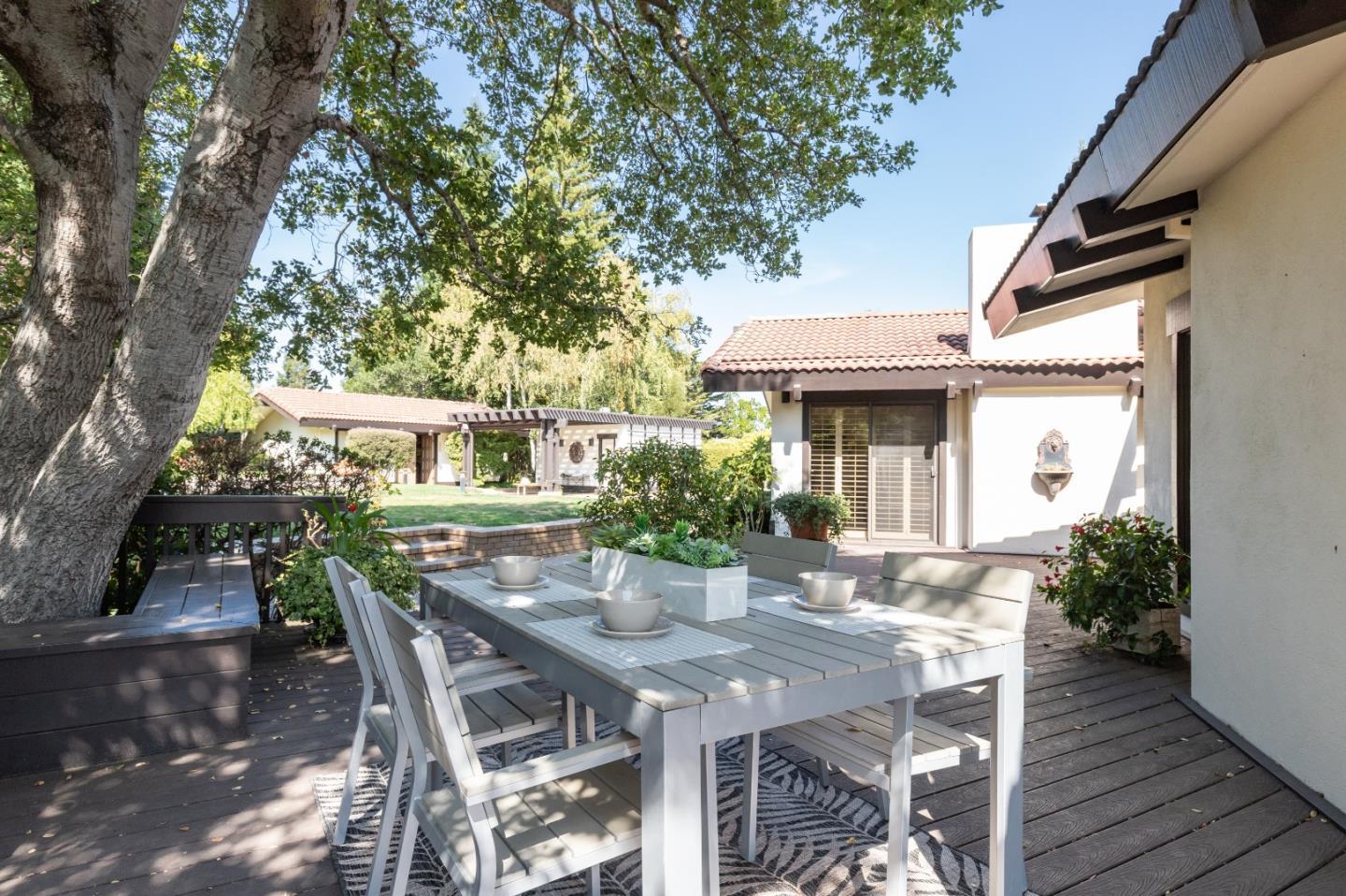 110 Stonepine Road Hillsborough, CA 94010 - Photo 24 of 28 a view of a patio with table and chairs and potted plants