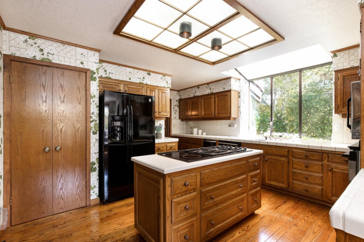 110 Stonepine Road Hillsborough, CA 94010 - Photo 9 of 28 a kitchen with stainless steel appliances granite countertop a stove a refrigerator and a sink