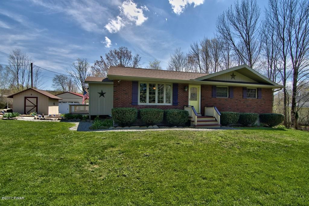 1058 Rosengrant Road Lake Ariel, PA 18436 - Photo 1 of 47 a front view of a house with a garden