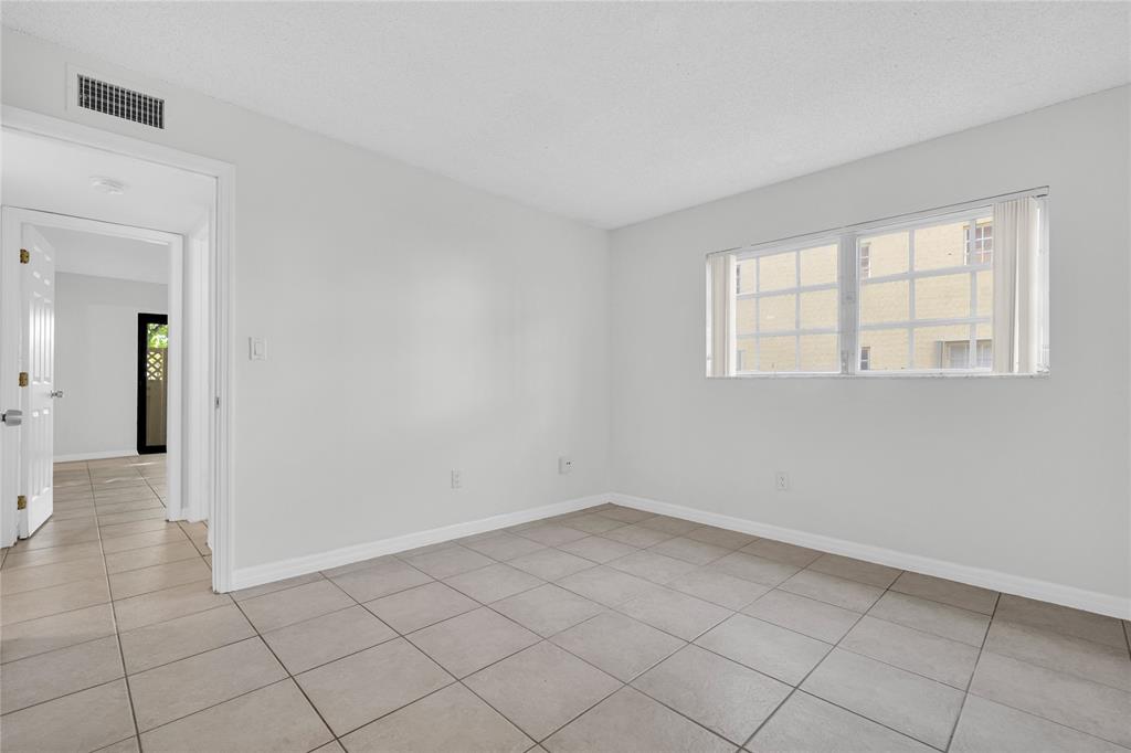 8600 Southwest 109th Avenue, Unit 4101 Miami, FL 33173 - Photo 14 of 34 wooden floor in an empty room with a window