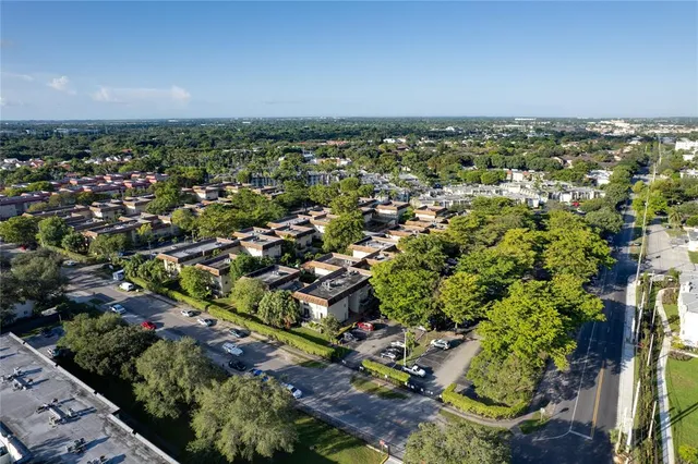 an aerial view of a house with a garden and a swimming pool
