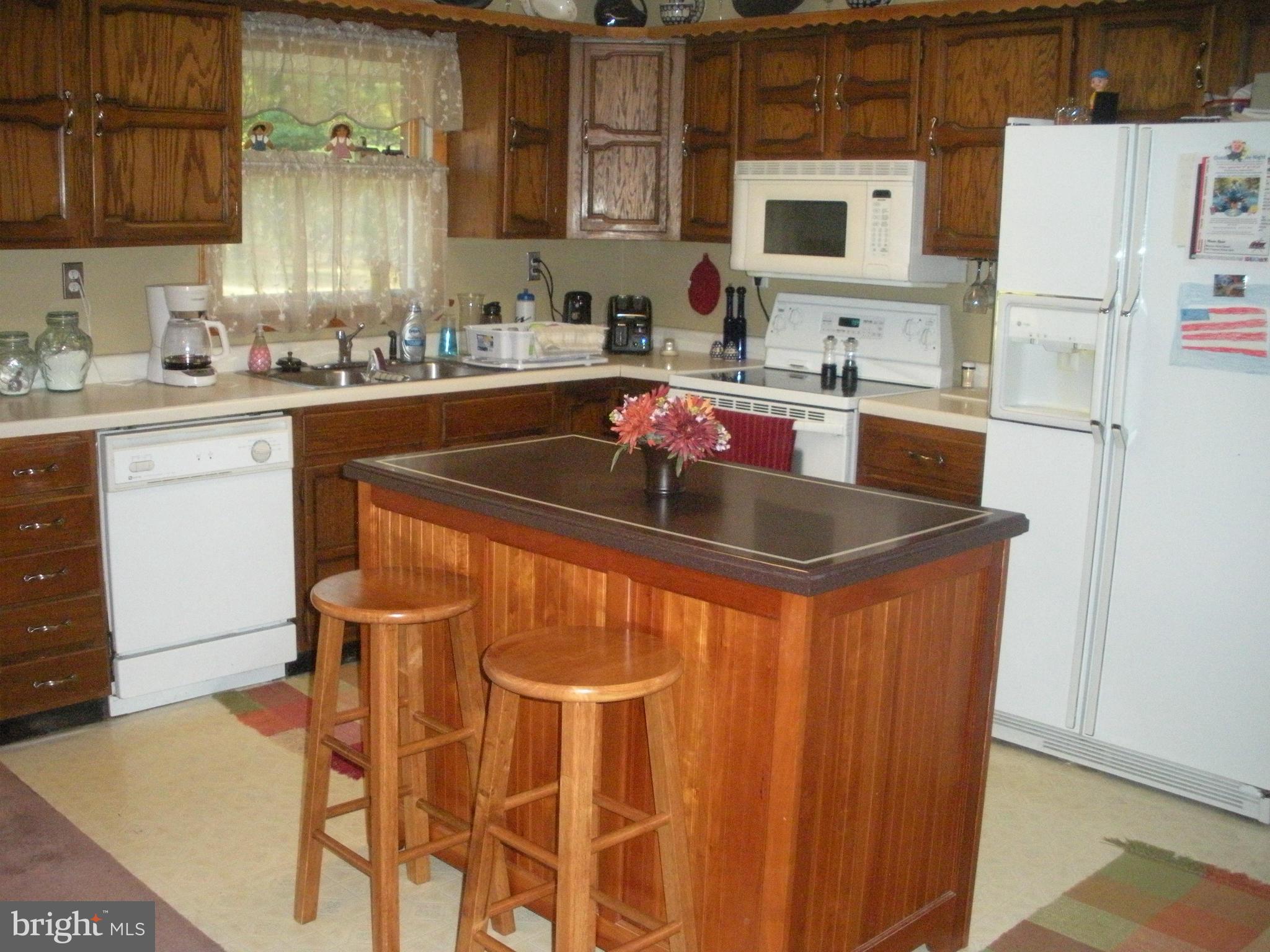 12309 Gramlich Road Southwest La Vale, MD 21502 - Photo 3 of 30 a kitchen with stainless steel appliances a sink and a refrigerator