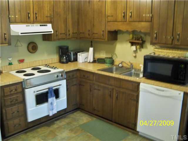 2893 Pilot-Riley Road Zebulon, NC 27597 - Photo 3 of 9 a kitchen with a sink and a stove top oven
