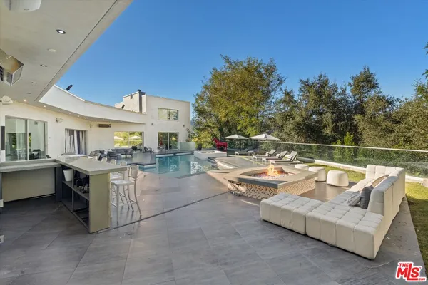 a view of a patio with couches and potted plants